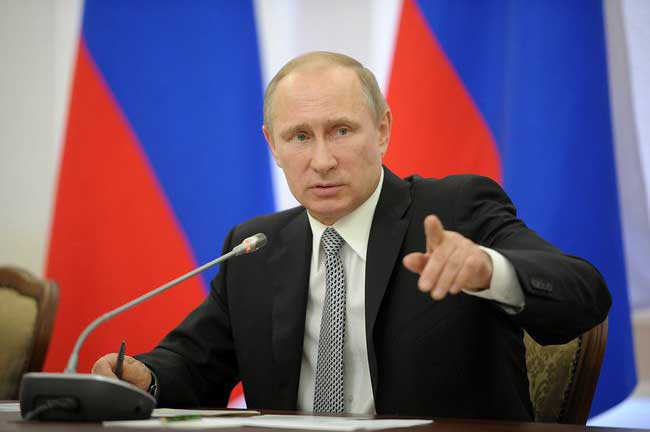 Vladimir Putin makes a point at meeting